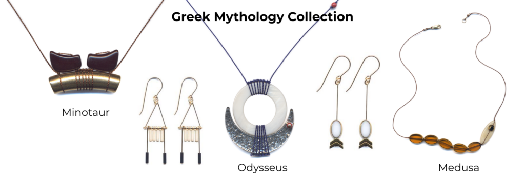 A sample of jewelry pieces from I. Ronni Kappos’ “Greek Mythology Collection” which was inspired by symbols and mythological characters of ancient Greece. Shown are the “Minotaur” necklace with a slightly curved downward gold-tone bead with pointed brown beads on top to mimic animal horns, a pair of earrings with a triangular frame from which small white cylindrical beads are hung from the bottom of the triangle with longer gold wire stems holding dark blue cylindrical beads, the “Odysseus” necklace with a mother of pearl flat circle bead with a hollow center from which a delicate blue cord is knotted in several wraps around the top and bottom which is also holding a vintage metallic lucite half-moon shaped bead nestled up to the mother-of-pearl-bead above, a pair of earrings with long gold wire stems holding a white oval bead with gold edging on top of 2 inverted chevron gold beads, and a “Medusa” necklace featuring 5 amber-colored beads linked together on a cord with an off-white pointed oval bead with a gold bead accent mimicking a snake with an eye.